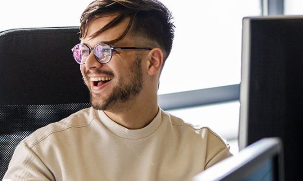 man working on computer laughing