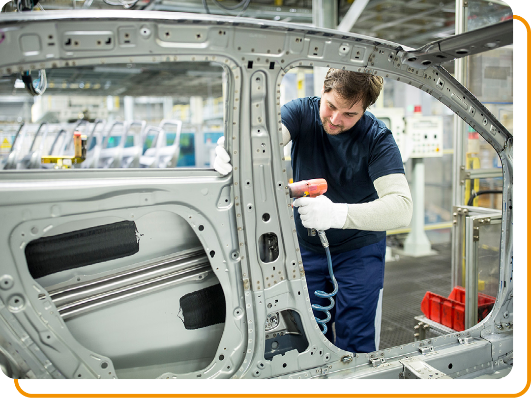 Image of a car mechanic building a car in a factory