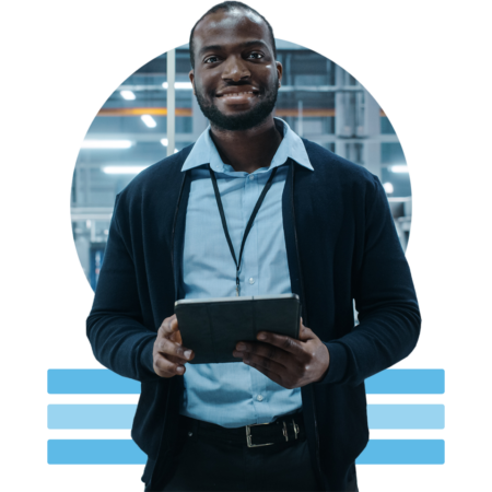 Image of a smiling person holding a tablet in a car factory