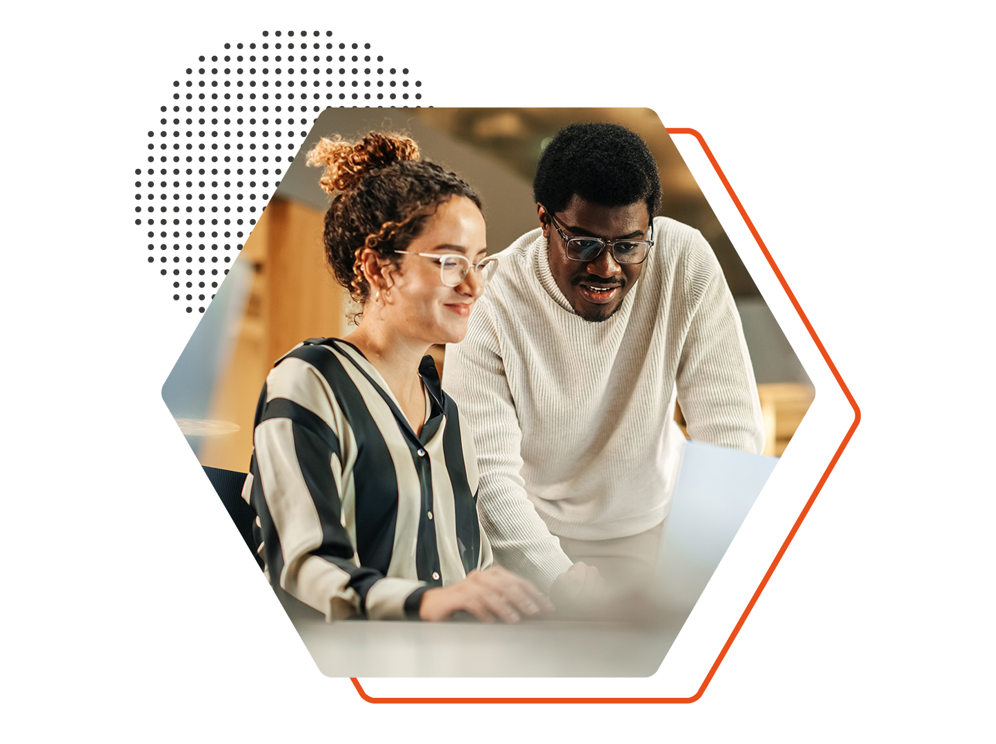 Image of two people working together on a laptop