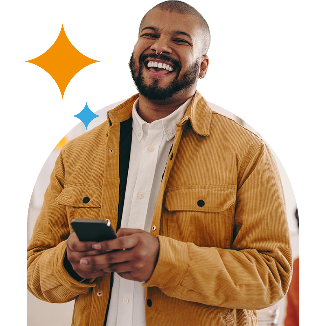 Image of a smiling business professional stood in an office on their mobile phone