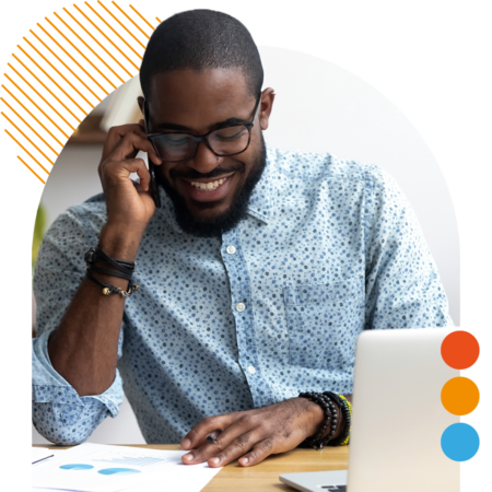 Image of a smiling professional working on a laptop
