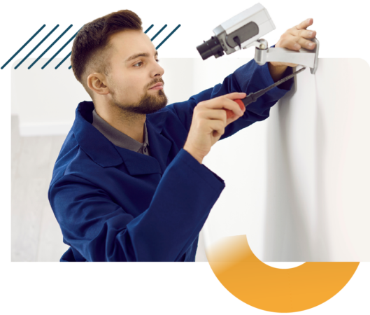 Person fitting a CCTV camera to a wall