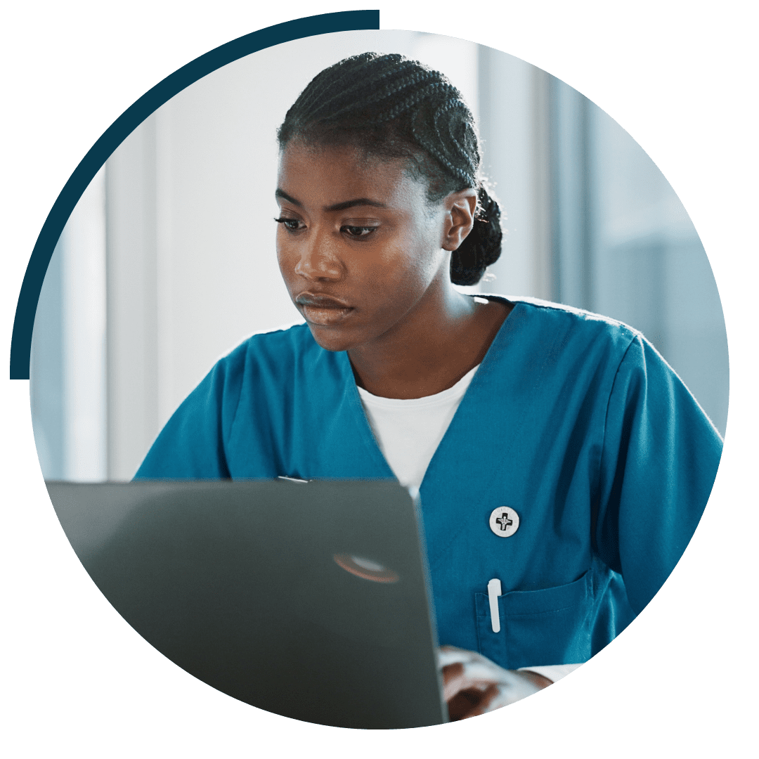 health professional sat at laptop