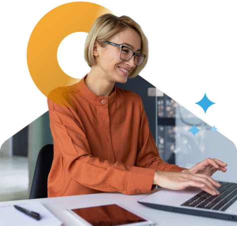 Person smiling while working on a laptop