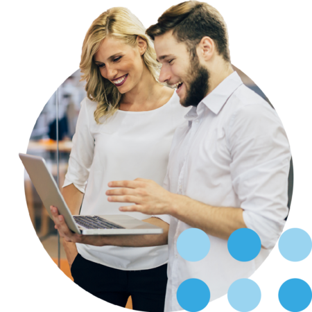 Image of two colleagues working together on a laptop