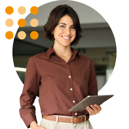 Image of an IT professional stood in an office holding a tablet