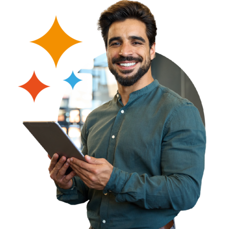 Image of a smiling person stood holding a tablet