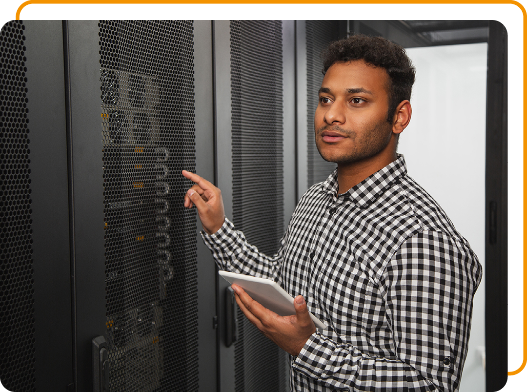 Image of an IT professional working on a tablet in a server room