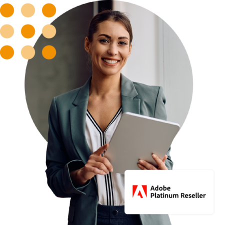 Image of a smiling business person stood in an office holding a tablet with our Adobe Platinum Reseller logo