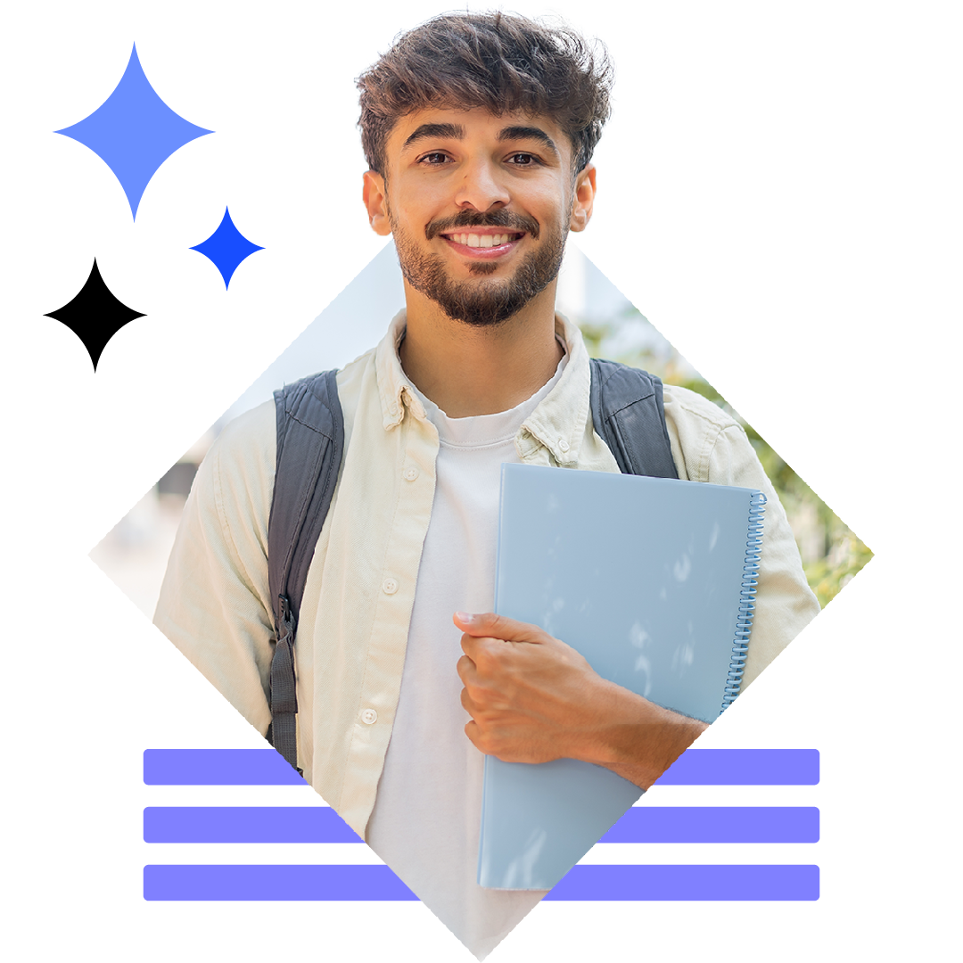 Image of a smiling student stood on campus with a laptop