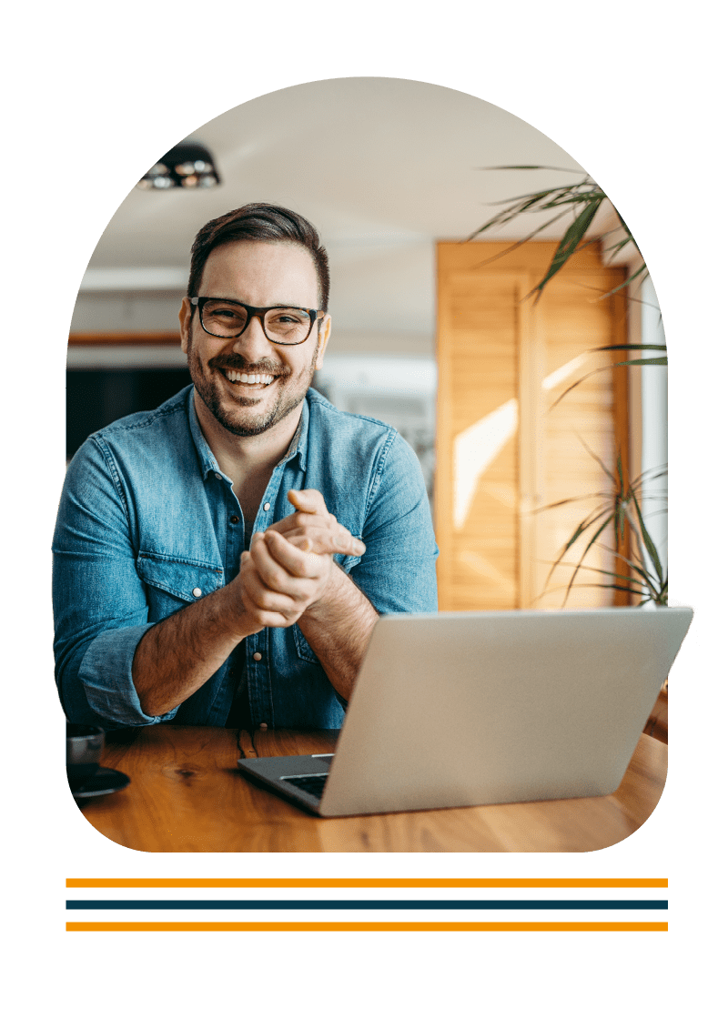 Portrait of a man sat at a desk using a laptop