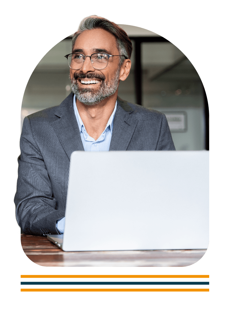 Portrait of a man sat at a desk using a laptop