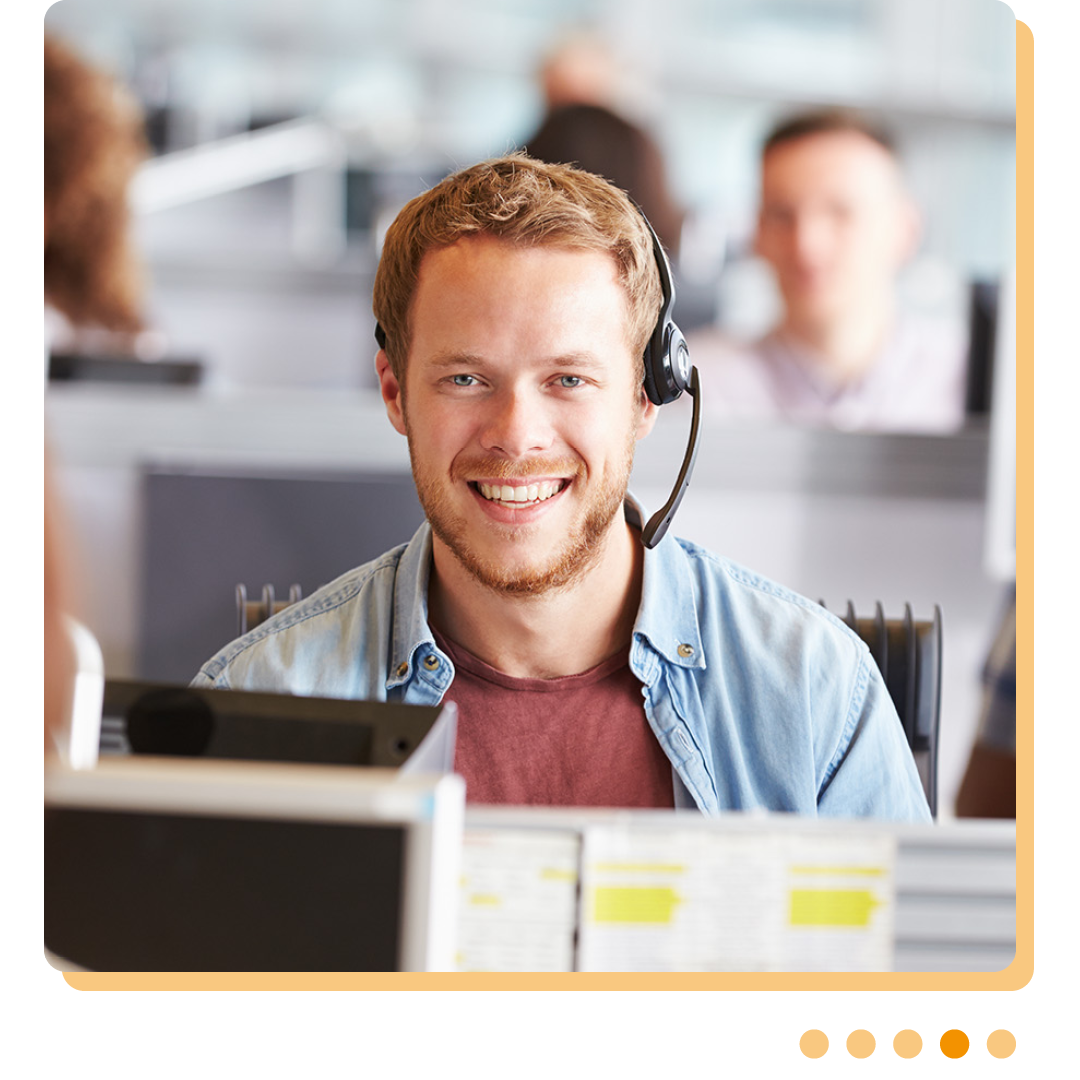Image of a smiling IT support professional wearing a headshet