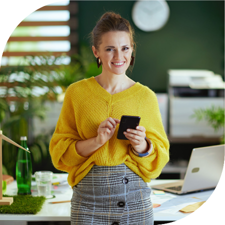 Image of a person stood in an office holding a mobile phone