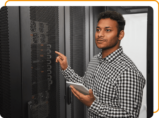 Image of an IT professional working on a tablet in a server room