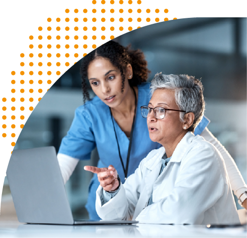 Two healthcare workers looking at laptop