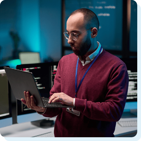 Image of a cyber security professional holding a laptop