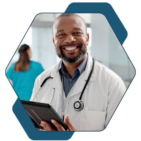 Male worker smiling in lab coat with ipad style tablet