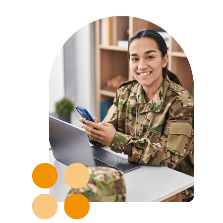 woman in army uniform with laptop and iphone smiling