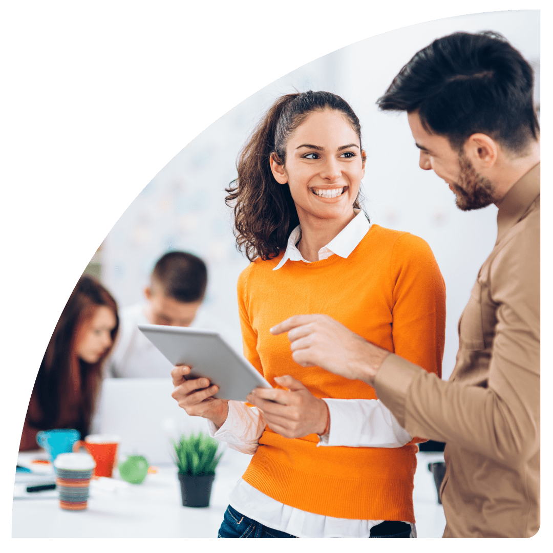 two people smiling looking at a tablet device