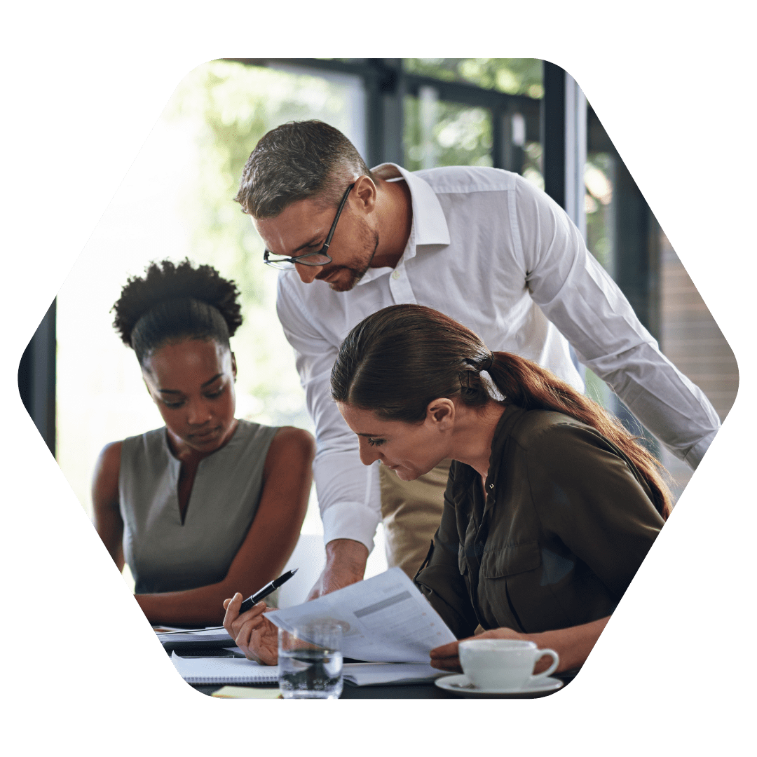 three people working together at desk