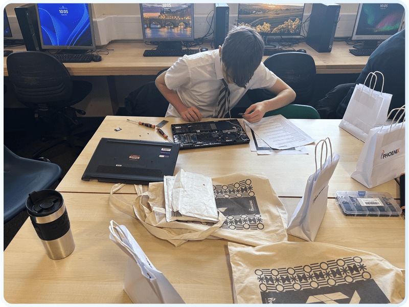 School students rebuilding laptops in a Phoenix educational workshop
