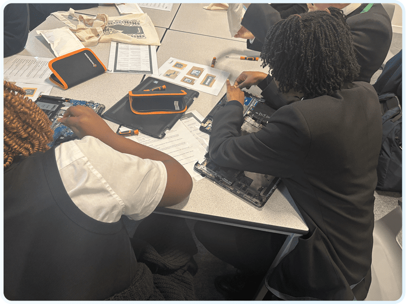 School students rebuilding laptops in a Phoenix educational workshop