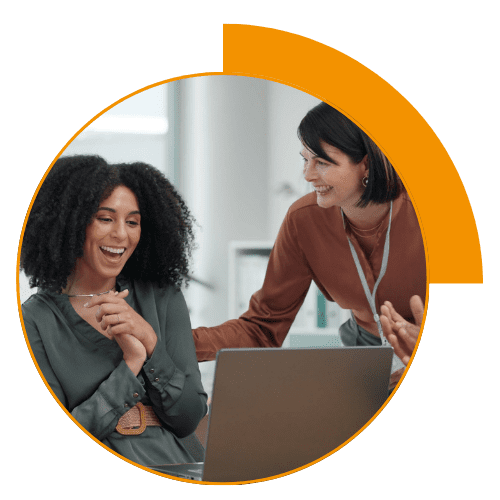 2 women talking and looking at a laptop