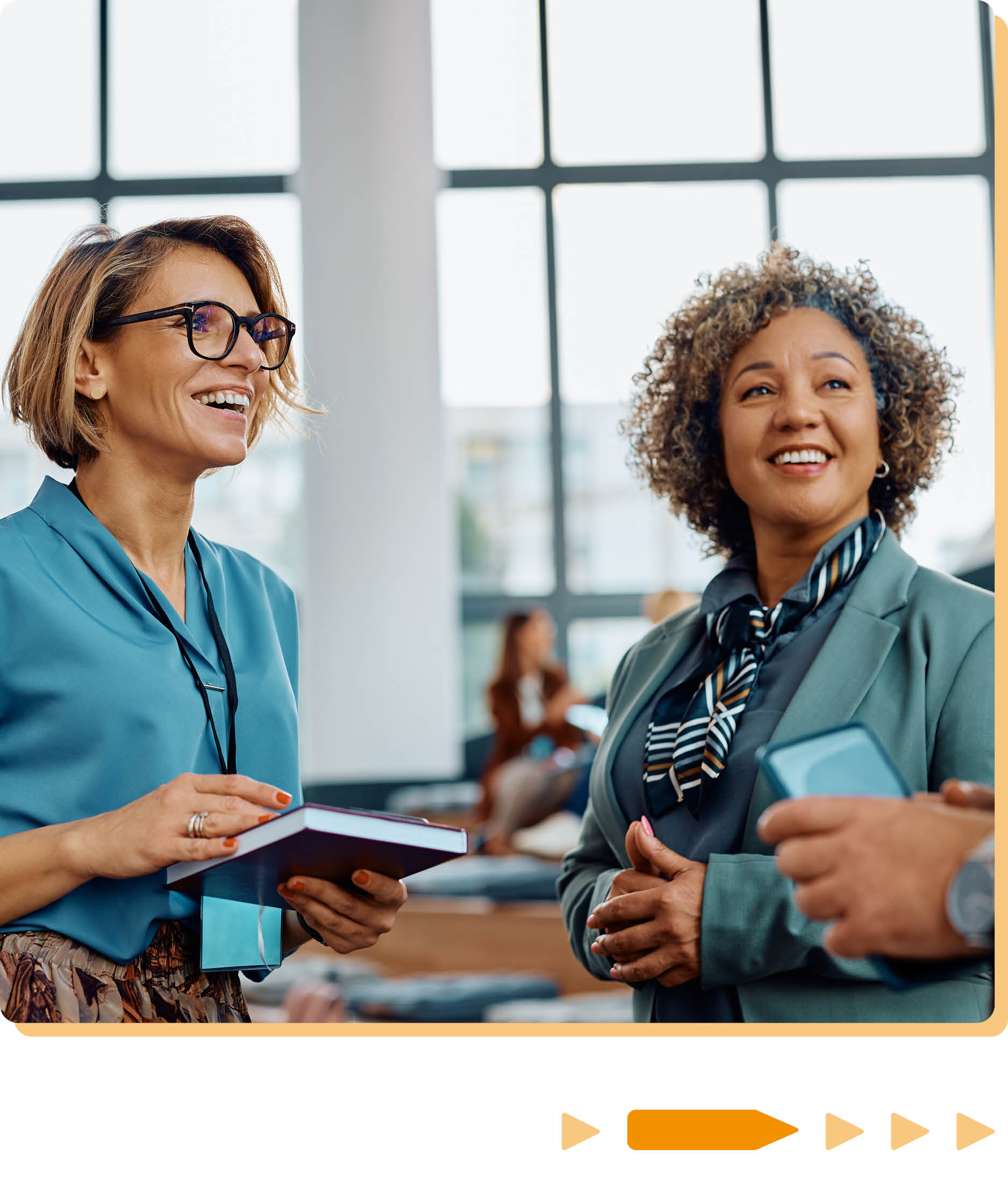 two women stood talking in business attire