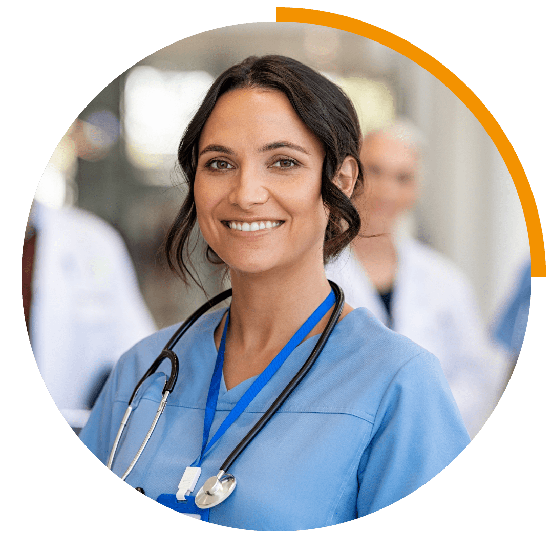 woman smiling in blue healthcare scrubs