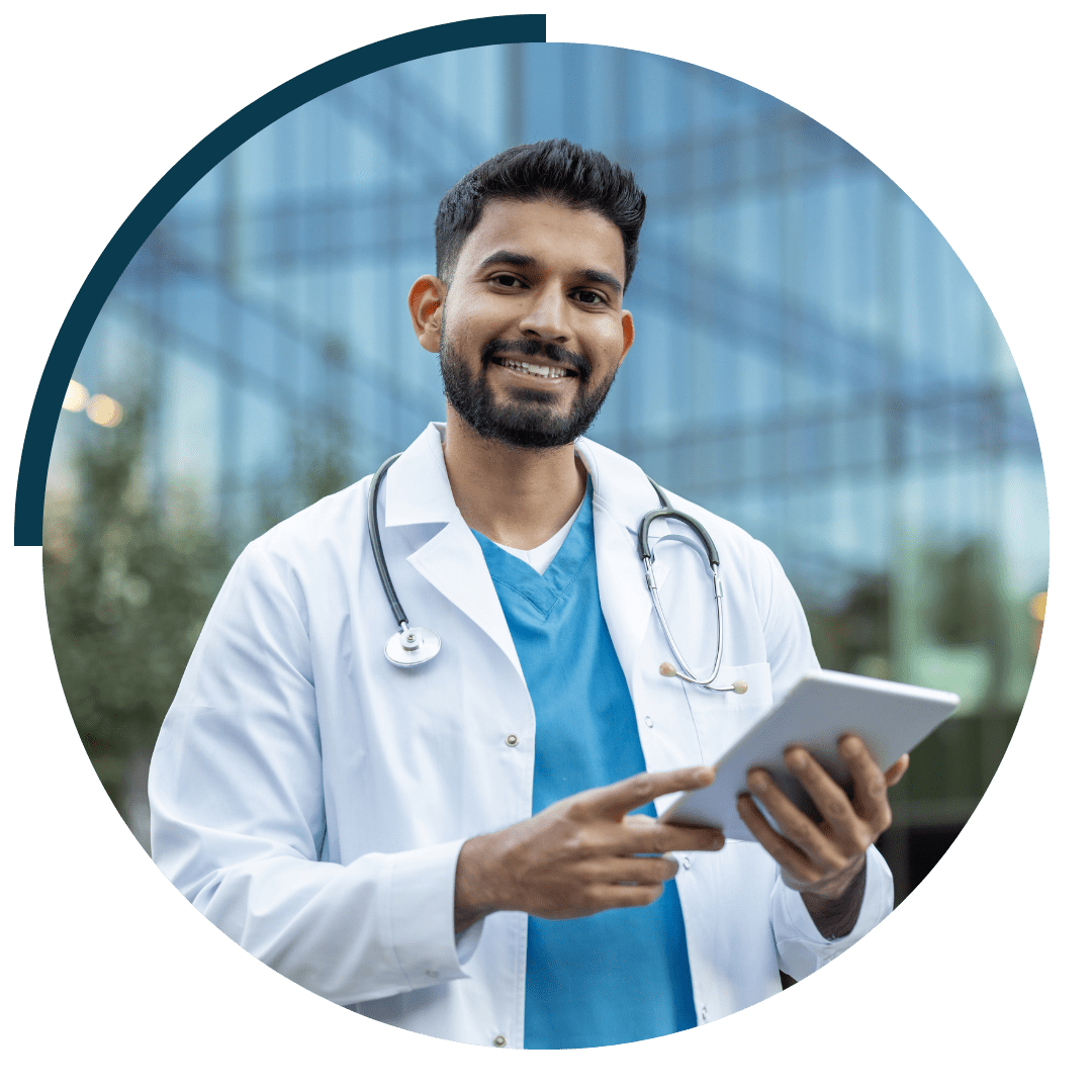 man smiling in healthcare uniform with tablet