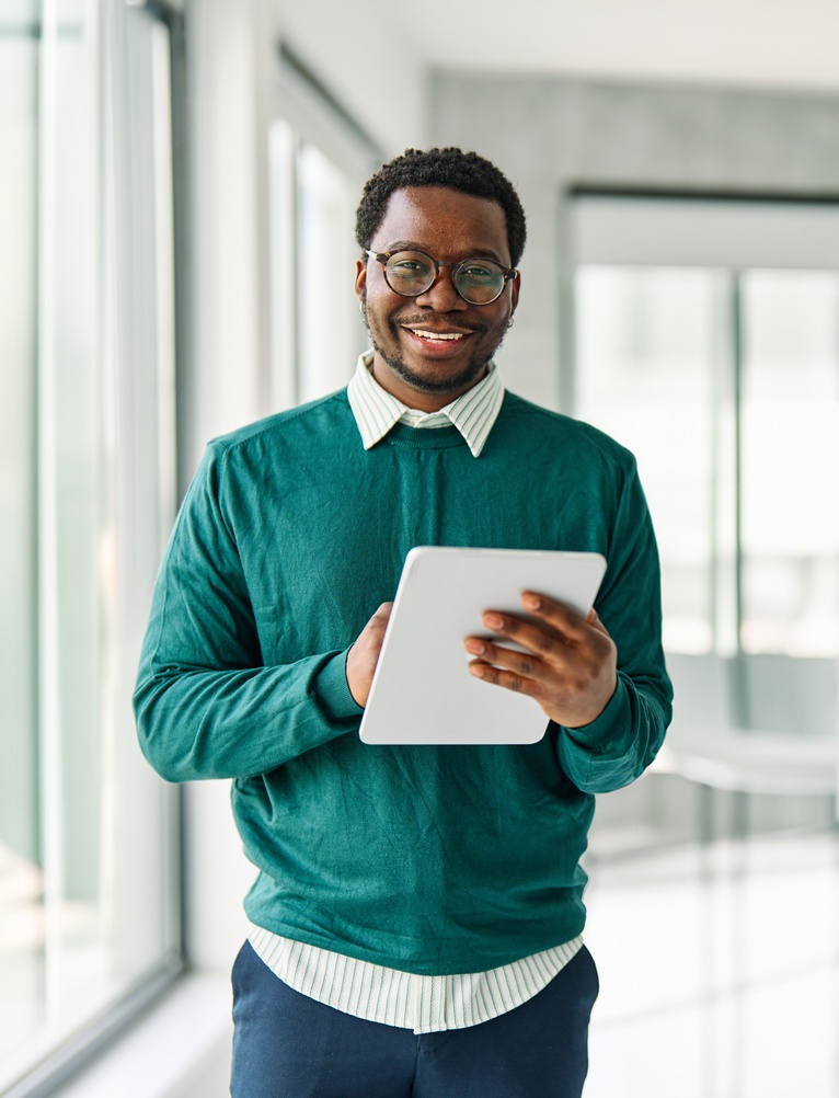 Business man stood holding tablet device